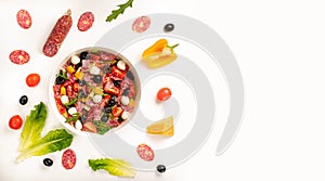Salad with tomato, olives, bell pepper, salami, mozzarella, lettuce and arugula on white background. Top view, concept