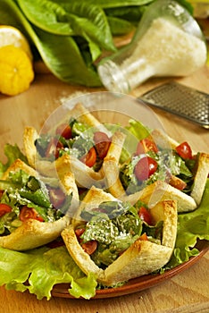 Salad with tomatoes and cheese in tartlets