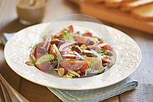 Salad with tomatoes, cucumbers, onion, beans and tuna sauce