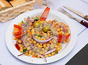Salad with tomatoes, olives with garbanzos and onion in restaurante
