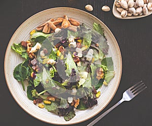 salad top view cenital bloc background fork healthy nuts lettuce cheese pistachio