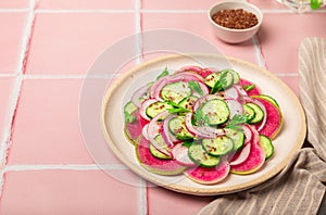 Salad with watermelon radish, cucumber and red onion