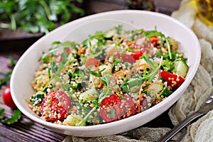 Salads with quinoa, arugula, radish, tomatoes and cucumber