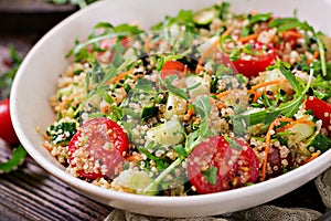 Salads with quinoa, arugula, radish, tomatoes and cucumber