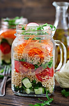 Salads with quinoa, arugula, radish, tomatoes and cucumber