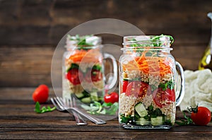 Salads with quinoa, arugula, radish, tomatoes and cucumber