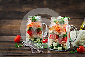 Salads with quinoa, arugula, radish, tomatoes and cucumber