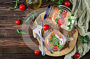 Salads with quinoa, arugula, radish, tomatoes and cucumber