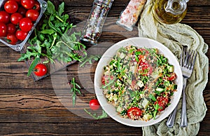 Salads with quinoa, arugula, radish, tomatoes and cucumber