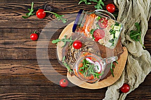 Salads with quinoa, arugula, radish, tomatoes and cucumber