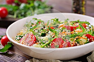 Salads with quinoa, arugula, radish, tomatoes and cucumber photo