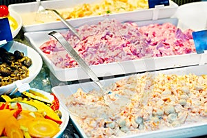 Salads, snacks and appetizers on counter