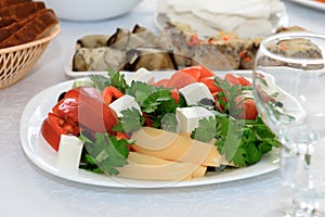 Salads and snacks in the assortment on the festive table.