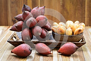 Salak or Salacca zalacca tropical fruit in wooden plate