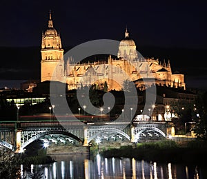 Salamanca skyline at night and Enrique Esteban Bridge over Tormes River photo