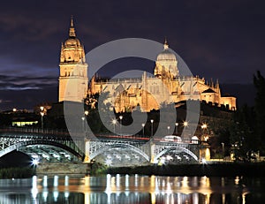 Salamanca skyline at night in Enrique Estevan bridge over Tormes River photo