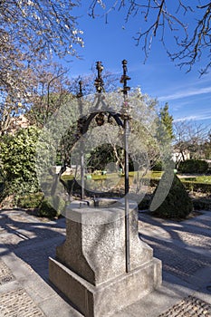 Trees and water well with love locks in Huerto de Calixto y Malibea, Salamanca, Spain