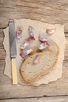 Salami and bread on an old kitchen table