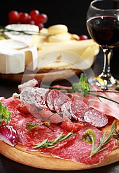 Salami and cheese platter with herbs