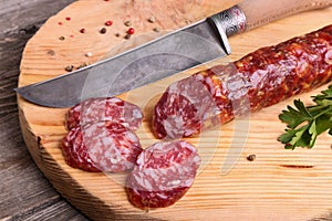 Salami and knife on a cutting board