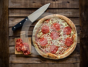 Salami Pizza on wood photo