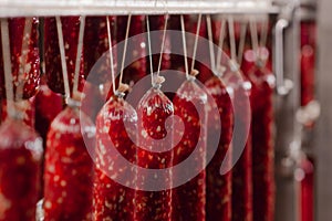 Salami production. Sausage production line. Sausage on the counter for the smokehouse