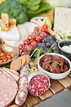 Salami sausage close-up. Table full of mediterranean appetizers, tapas or antipasto. Assorted Italian food set