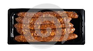 Salami sausages in black transparent vacuum packaging isolated on white