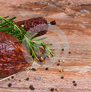 Salami slices with pepper and rosemary