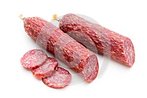 Salami smoked sausage, basil leaves and peppercorns isolated on