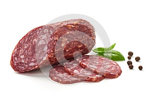 Salami smoked sausage, basil leaves and peppercorns, isolated on white background