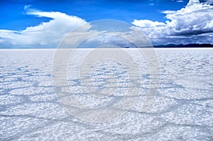 Salar de Uyuni Bolivia salt desert and cloudy blue sky