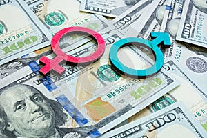 Salary and wage gap concept. Gender symbols and money. photo