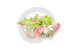 Salat with tomato and cheese in a bowl