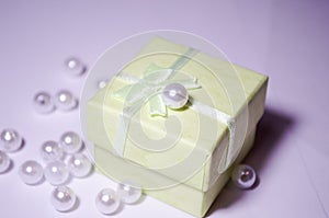 Salatne box with a pearl. Bead on the box. Plastic bead. Placer beads. White beads. photo