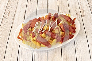 Salchipapa or salchipapas is a fast food consisting of fried slices of sausage and French fries, consumed photo