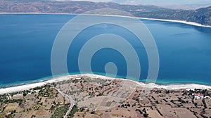 Salda mountain blue crater lake with white volcanic sand, panoramic drone video.