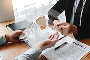 Sale Agent handshake with woman customer and sign agreement documents for realty purchase after successful loan contract