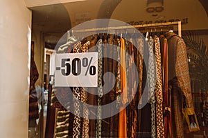 Sale banner in shop window for end of the season sales deals