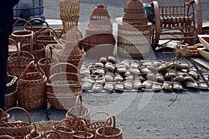 Sale of baskets of willow twigs and wicker bast shoes. Wicker baskets of various shapes and sizes. Handmade. Craft