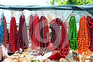 Sale of beautiful colorful women`s jewelry made of wooden beads. Fair - an exhibition of folk craftsmen