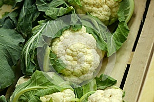 Sale of a cauliflower close up against the background of a wooden box
