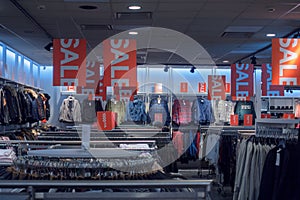 Sale in a clothing store, interior of clothes shop