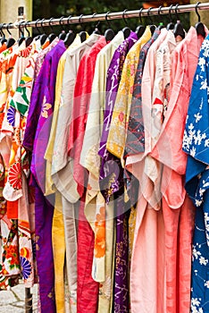 Sale of colorful kimonos on the city street in Kyoto, Japan. Close-up. Vertical.