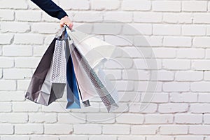 Sale, discount, black friday concept. Man with bunch of shopping bags. Copy space. Shopping mall and outlet