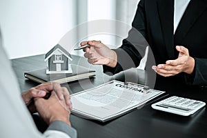 Sale Estate agent are presenting home loan to customer to decision signing contract to rental house insurance with approved