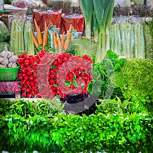 Sale of fresh organic different kinds of vegetables and greens in farmer`s bazaar, open showcases of vegetable market