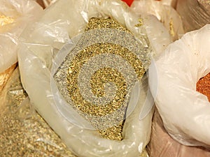 Sale of friable cereals and seasonings in open bags on a bazaar counter. Trade in cereals and medicinal herbs of traditional