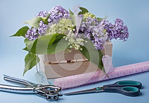 Sale of lilac bouquets in a wooden box.