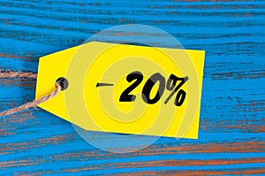 Sale minus 20 percent. Big sales twenty percents on blue wooden background for flyer, poster, shopping, sign, discount photo